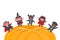 Halloween kids party template. Children in Halloween costumes dance on holiday pumpkin. Diverse group of kids have fun