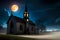 Halloween landscape with old church at moonlit night