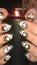 Halloween manicure. Witch`s hands are holding a burning candle. Halloween concept, black art.