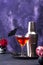 Halloween martini cocktail on purple background