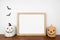 Halloween mock up wooden frame on a wood shelf with jack o lantern decor