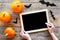 Halloween mockup. Chalkboard near paper bats and pumpkins on wooden background top view