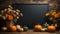 Halloween mockup space with pumpkins, lantern and fallen leaves. Black board with autumn holiday decoration with copy space.