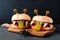 Halloween monster hamburgers against a black background