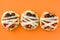 Halloween mummies mini pizzas on orange background