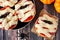 Halloween mummy mini pizzas overhead scene on rustic wood