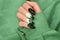Halloween nail design with green shade color with cross. Female hand with autumn manicure, top view. Halloween concept