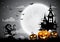 Halloween night background with pumpkin, haunted house and full moon