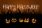 Halloween night fiery smiles of pumpkins and calligraphic inscription Happy Halloween.