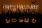 Halloween night fiery smiles of pumpkins and calligraphic inscription Happy Halloween