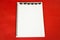 Halloween notepad. Red background. Blank note sheet surrounded by spiders. Traditional decor. Blank for an invitation to halloween