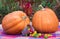 Halloween orange pumpkins and colorful candy in a bucket