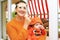 Halloween party with baby, mother holding child wearing pumpkin costume