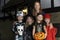 Halloween Party With Children Trick Or Treating In Costume With