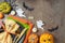 Halloween party concept with plate, pumpkin and decorations on dark background. Top view, flat lay