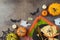 Halloween party concept with plate, pumpkin and decorations on dark background. Top view, flat lay