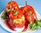 Halloween party food. Red stuffed peppers with scary cutout faces close up