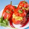 Halloween party food. Red stuffed peppers with scary cutout faces close up