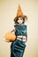 Halloween Party girl. Witch hat. Happy Halloween witch with pumpkin. Young woman with witch hat dressed as vampire for