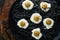 Halloween party Italian black pasta decorated horror  olives like eyes on black plate on old dark table background. Monster face f