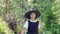 Halloween party. portrait of teen girl in witch costume. holding magic wand and book,