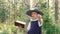 Halloween party. portrait of teen girl in witch costume. holding magic wand and book,
