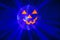 Halloween party pumpkin disco ball, jack o`lantern with shiny rays in smoke