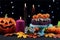 Halloween party table with chocolate cupcakes, spiders, pumpkins