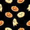 Halloween pattern. Cookies in the shape of pumpkins, skulls and ghosts on a black background