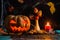 Halloween photo of table with pumpkin, biscuits, dried flowers, burning candle