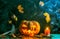 Halloween photo of table with pumpkin, burning candle, cobweb