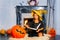 Halloween portrait of girl cast spell on pumpkin