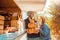 Halloween Preparaton Concept. Young couple decorating house with pumpkins looking at each other happy