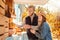 Halloween Preparaton Concept. Young couple decorating house with pumpkins smiling happy