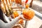 Halloween Preparaton Concept. Young man decorating house with jack-o`-lantern holding pumpkin close-up