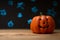 Halloween pumpkin on a background of blue blurry stars, lights. With space for design, festive mood