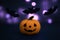 Halloween pumpkin and bats on dark blue background with bokeh. Woolen felting toys Jack pumpkin head