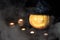 Halloween pumpkin on a black background with candles and foggy smoke. Halloween holiday