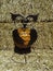 Halloween Pumpkin in an black metal Owl display in front of straw bales