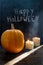 Halloween pumpkin on a black wooden background