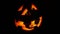 Halloween pumpkin blinking on black background,