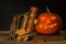 Halloween pumpkin and a book of spells. Carved pumpkin. Magic books. Traditional holiday.