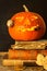Halloween pumpkin and a book of spells. Carved pumpkin. Magic books. Traditional holiday.