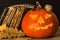 Halloween pumpkin and a book of spells. Carved pumpkin. Magic books. Traditional holiday.