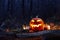 Halloween pumpkin burning in forest at night