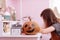 Halloween pumpkin and calendar with 31 october on wooden table in schoolgirls room. child girl on backgroung doing