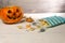 Halloween pumpkin and candies on a white table