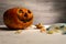 Halloween pumpkin and candies on a white table