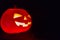 Halloween pumpkin. Candles, bat and glowing pumpkin. Harvest for Halloween. Dark atmosphere for holiday