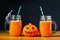 Halloween pumpkin with carrot juice in masons jars